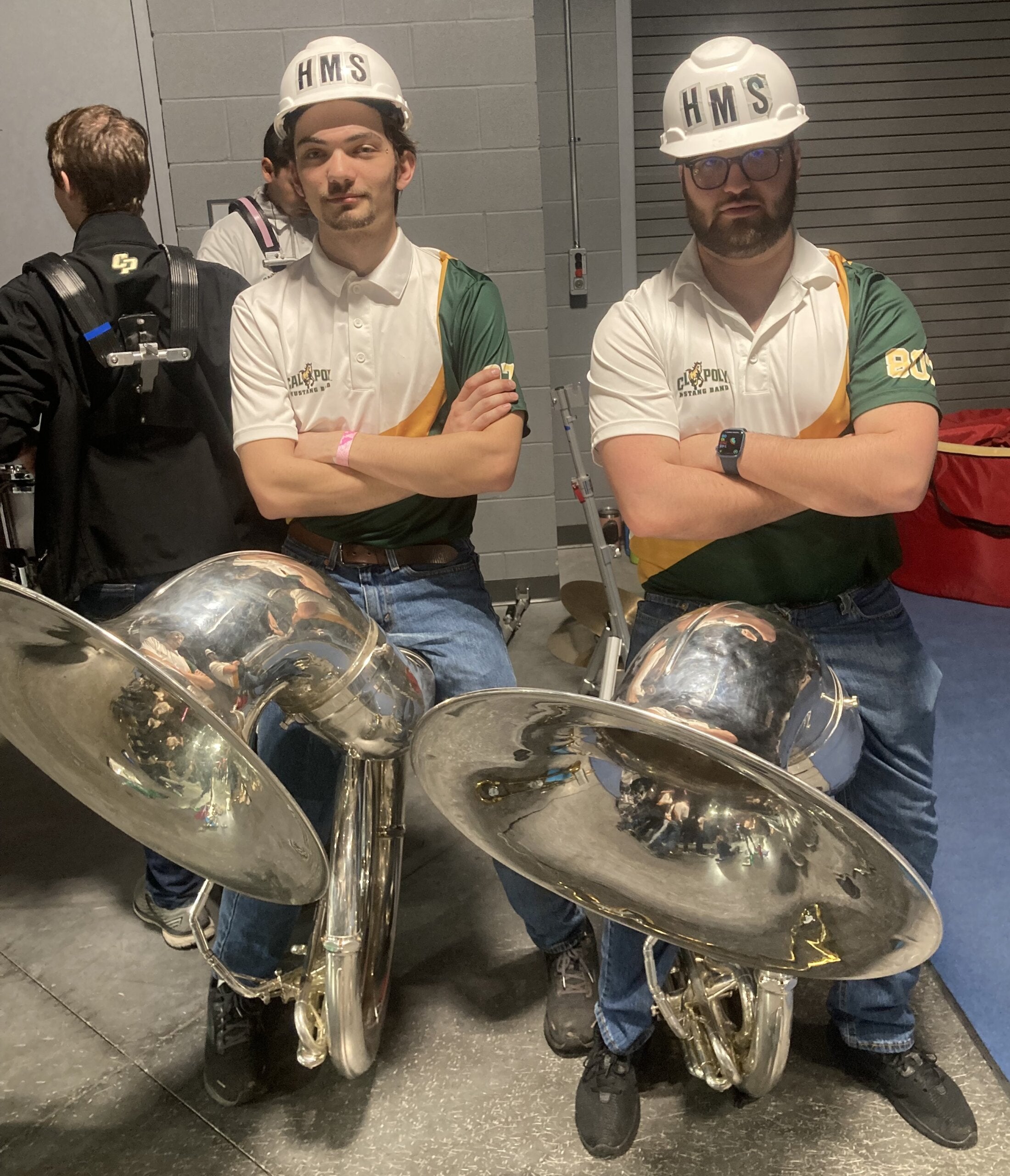 Andrew Osborn sits next to a friend with his sousaphone