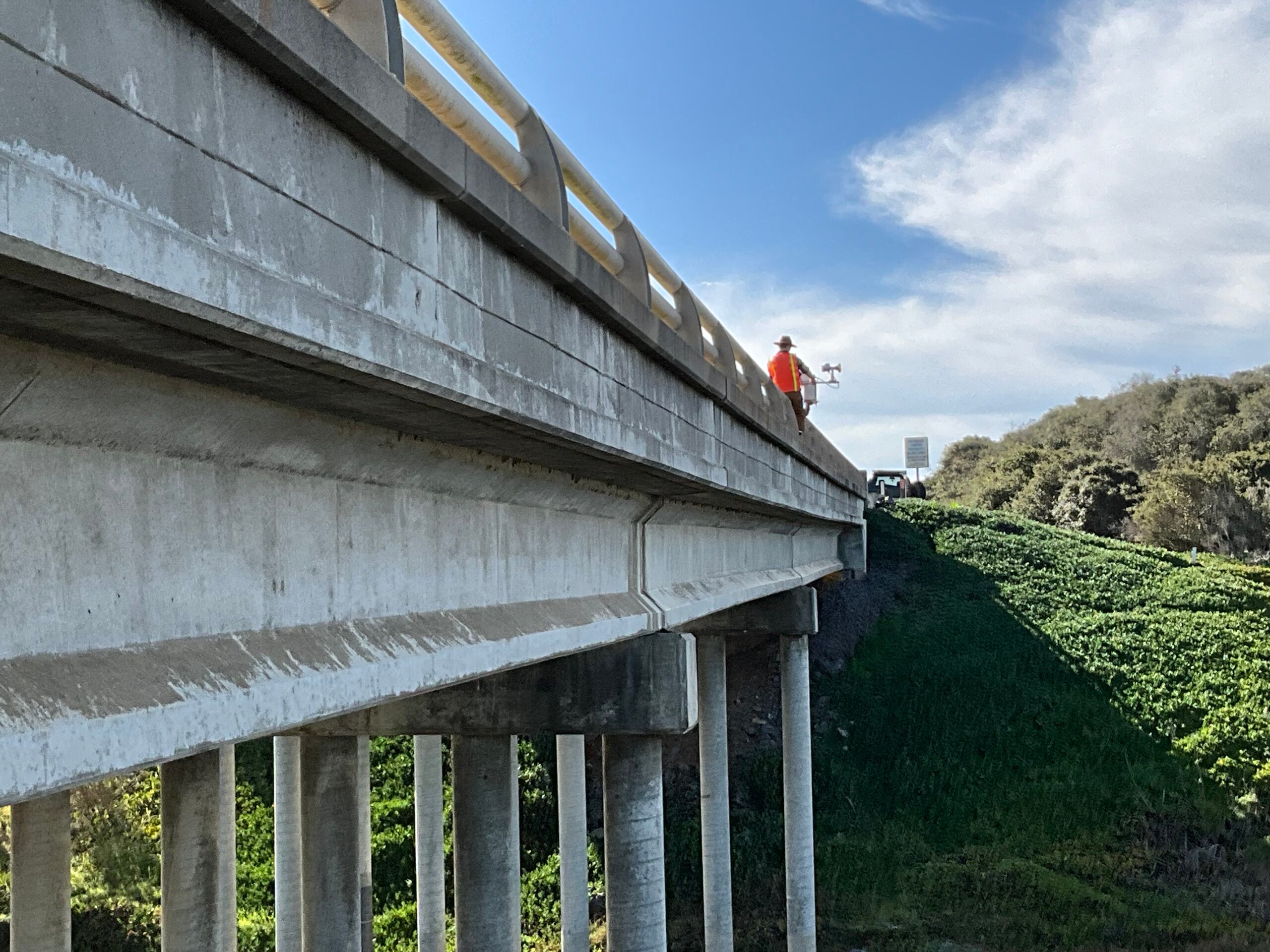 Research fellow Serena Lee installs a tide gauge on a bridge