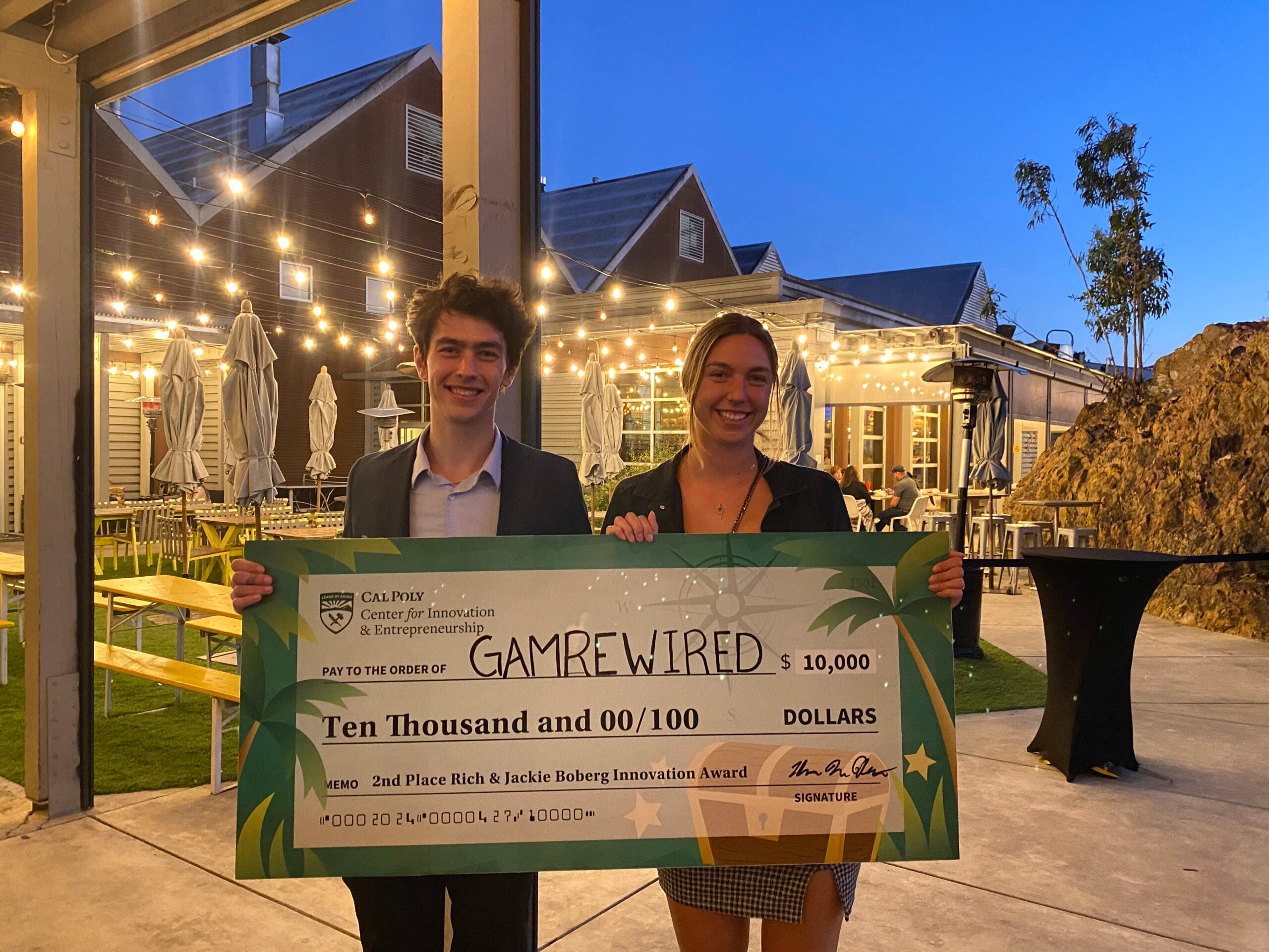 Two people holding a giant check.