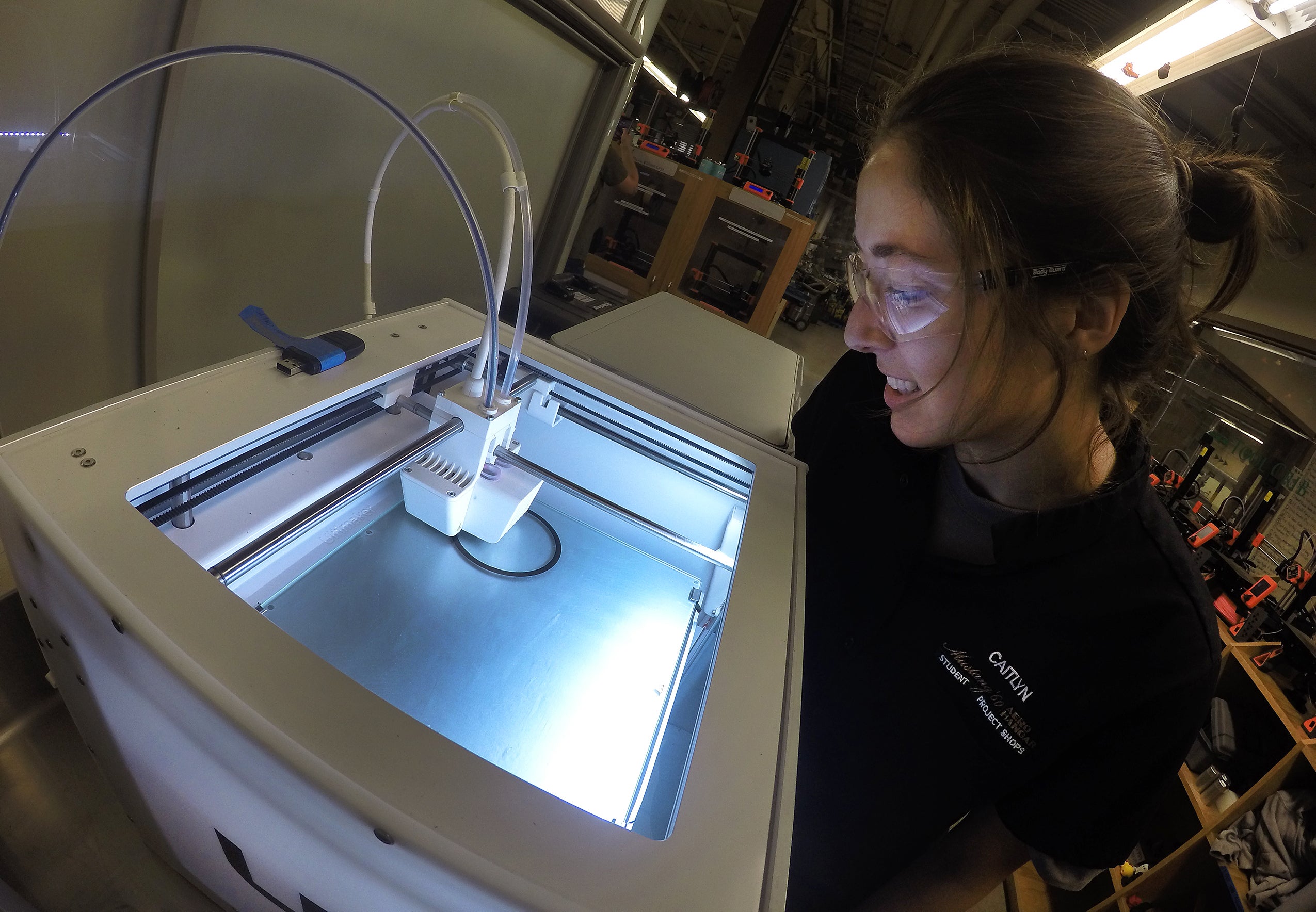 Shop tech works with a 3D printer in the shop