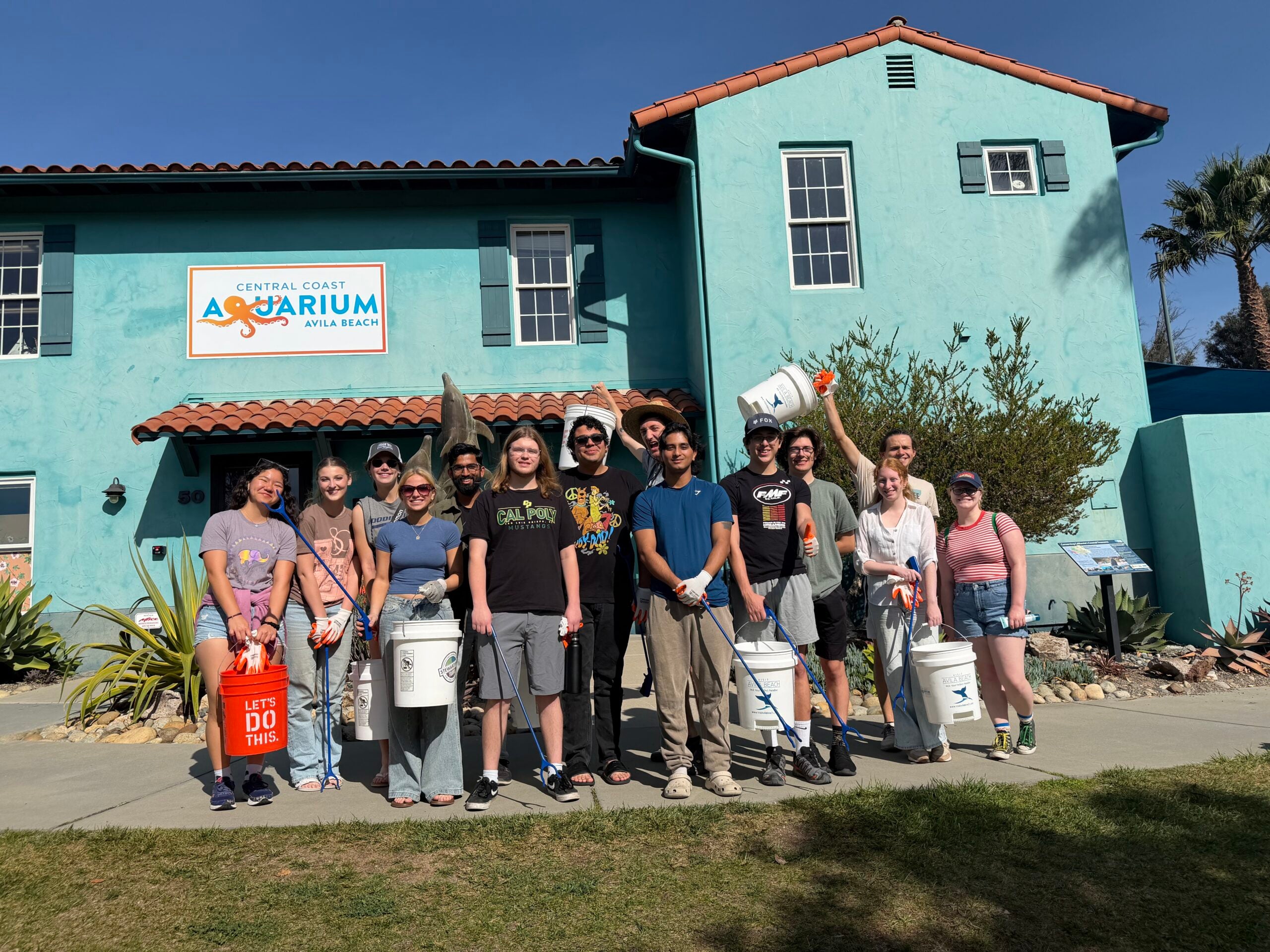 CAPED members pose outside the Central Coast Aquarium before a beach cleanup