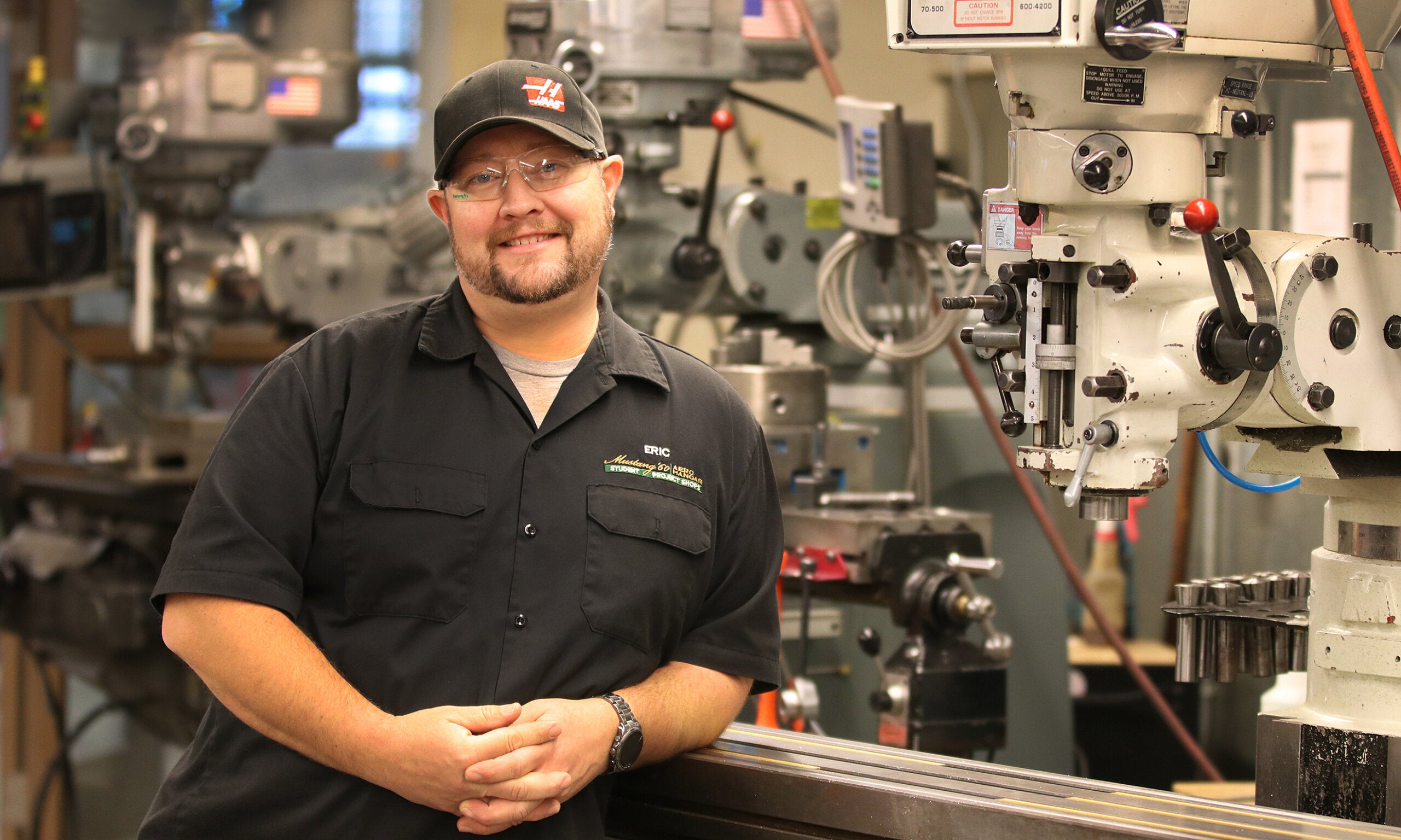 Shop manager Eric Pulse stands next to the machinery in the Mustang '60 machine shop
