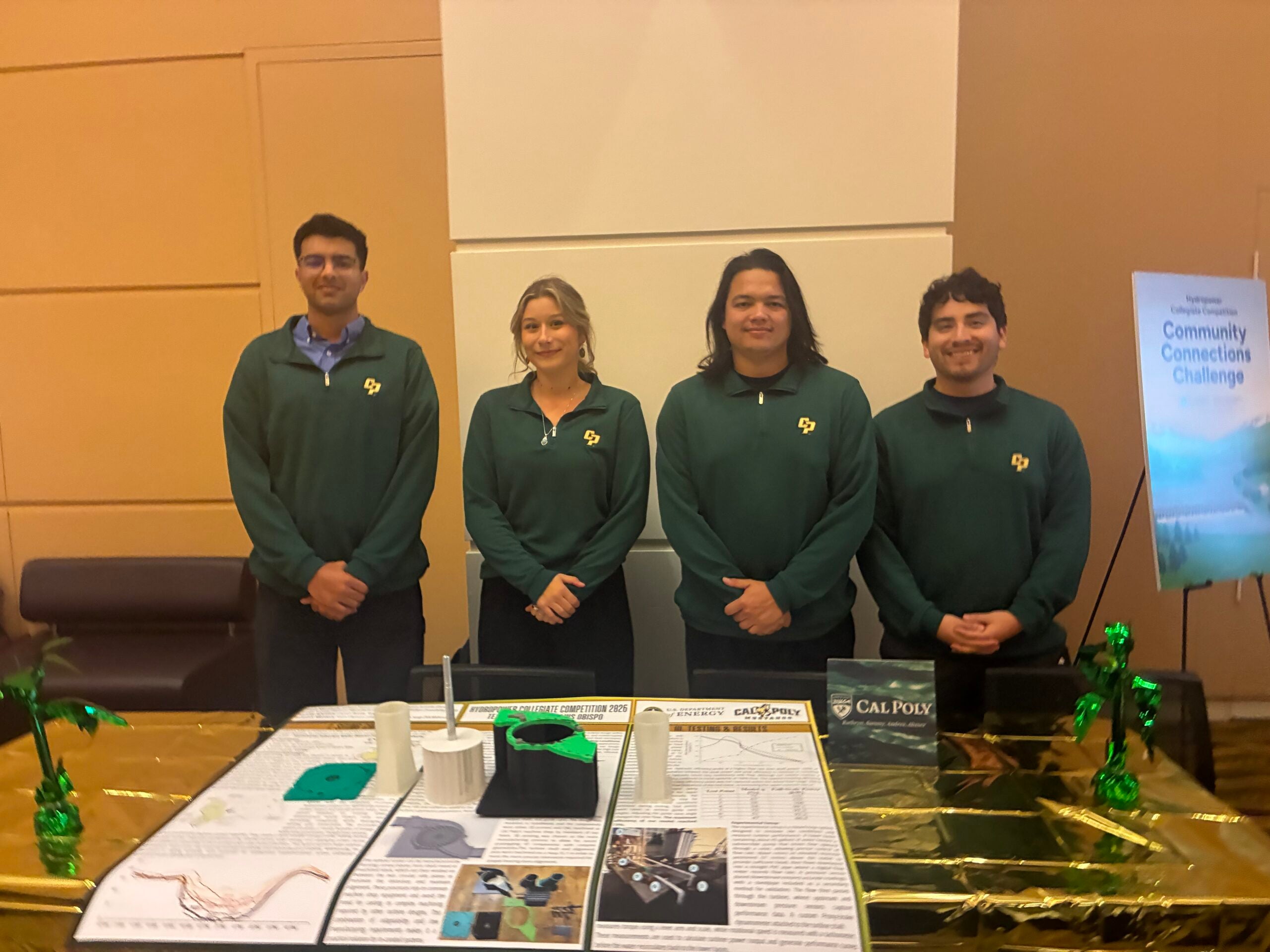 Students stand next to their hydropower display