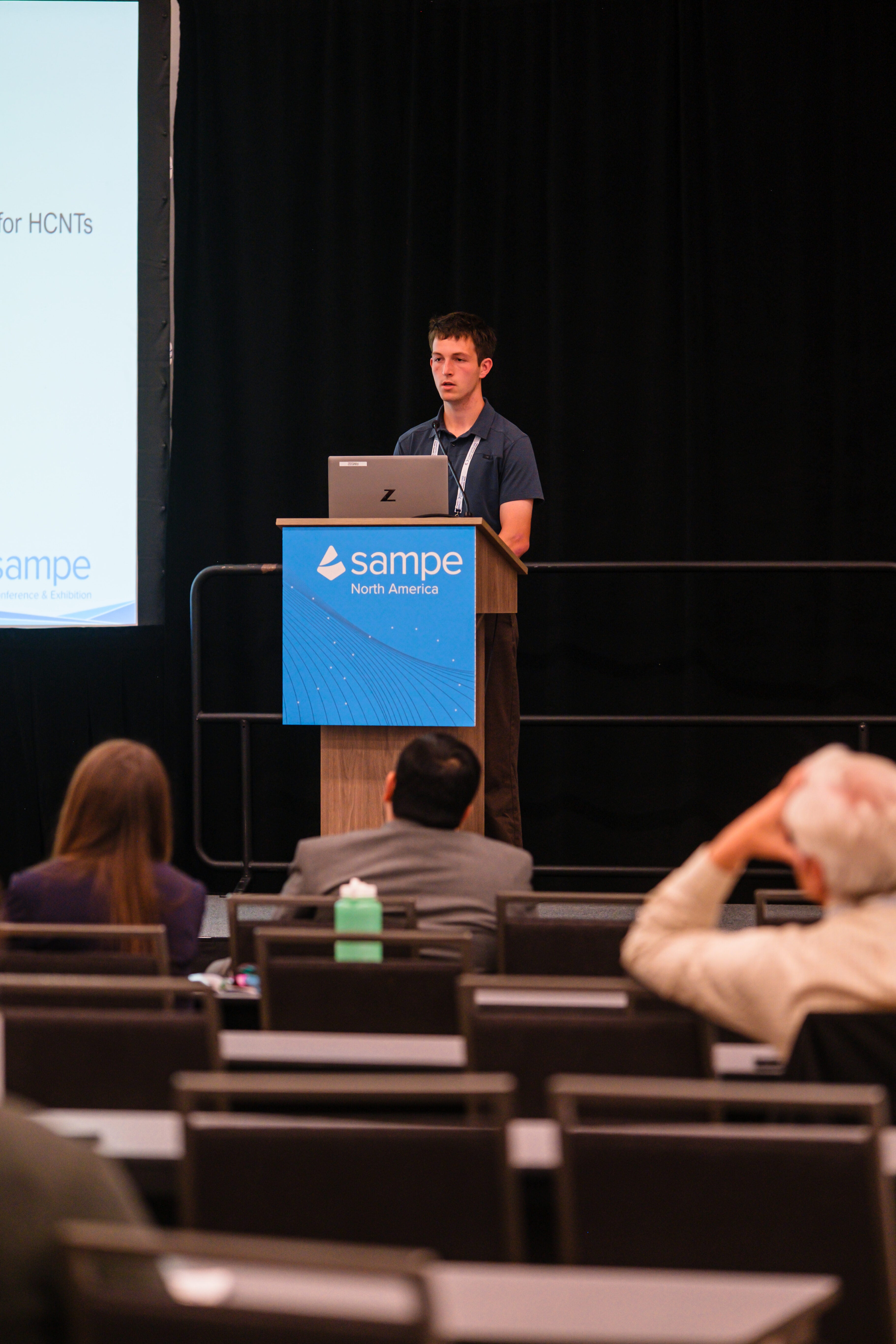 A student speaking at a podium