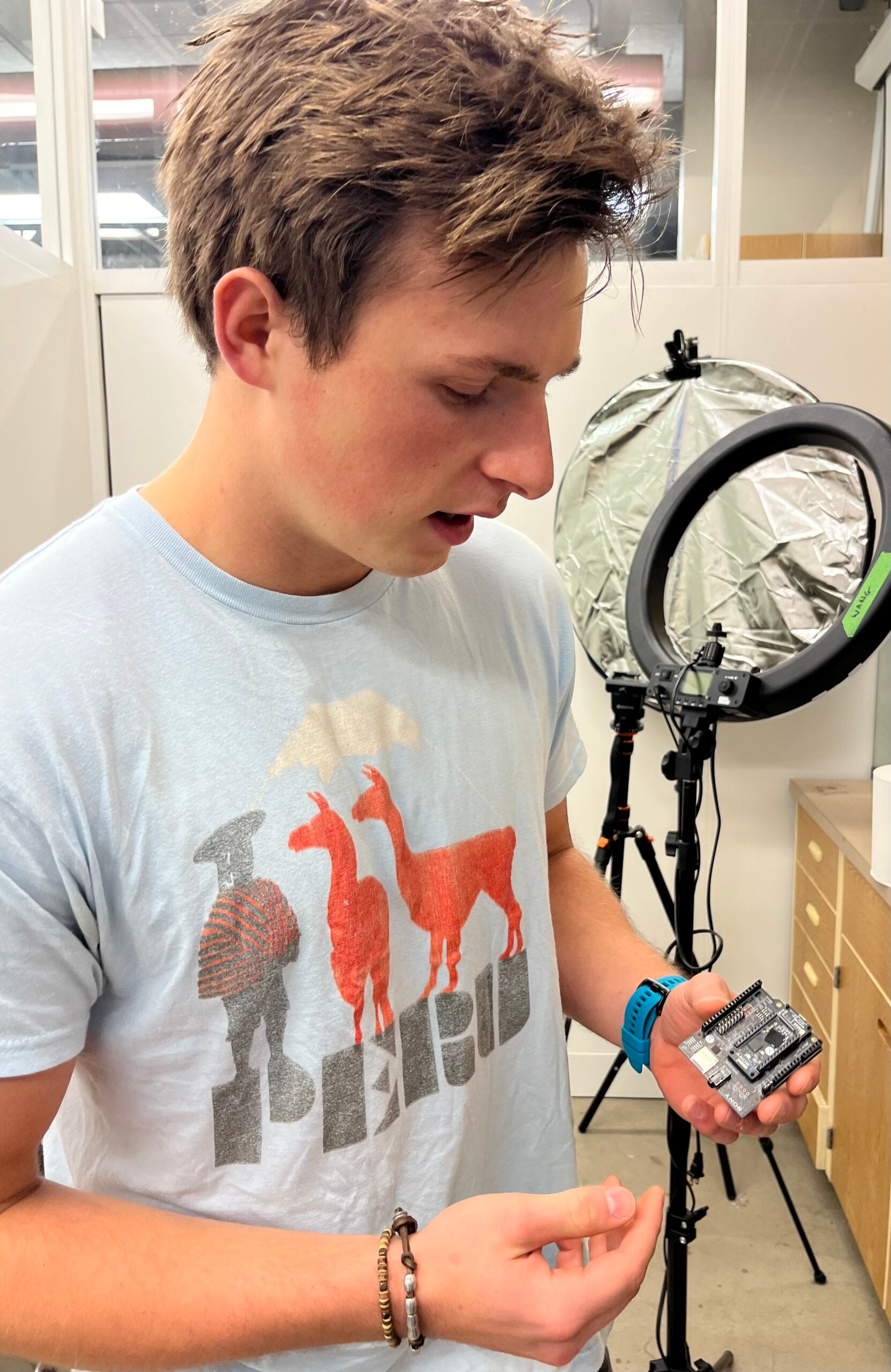Student displays an electronic board that will be incorporated into a project with Sony