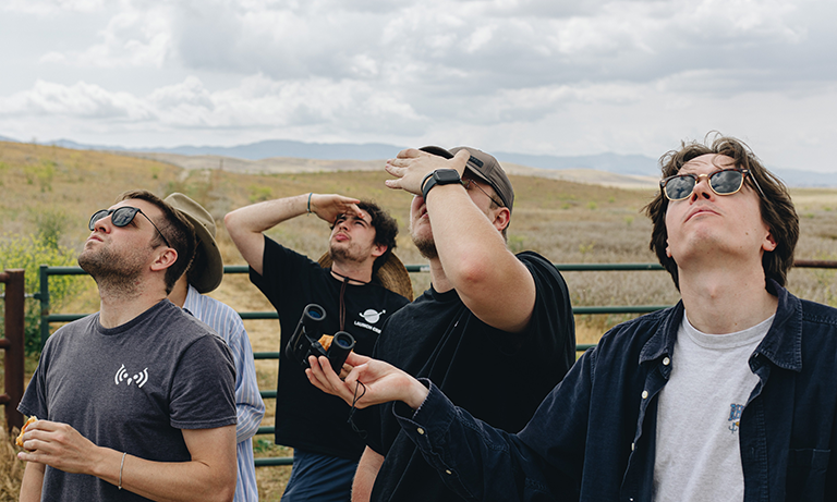 Five people looking up at the sky