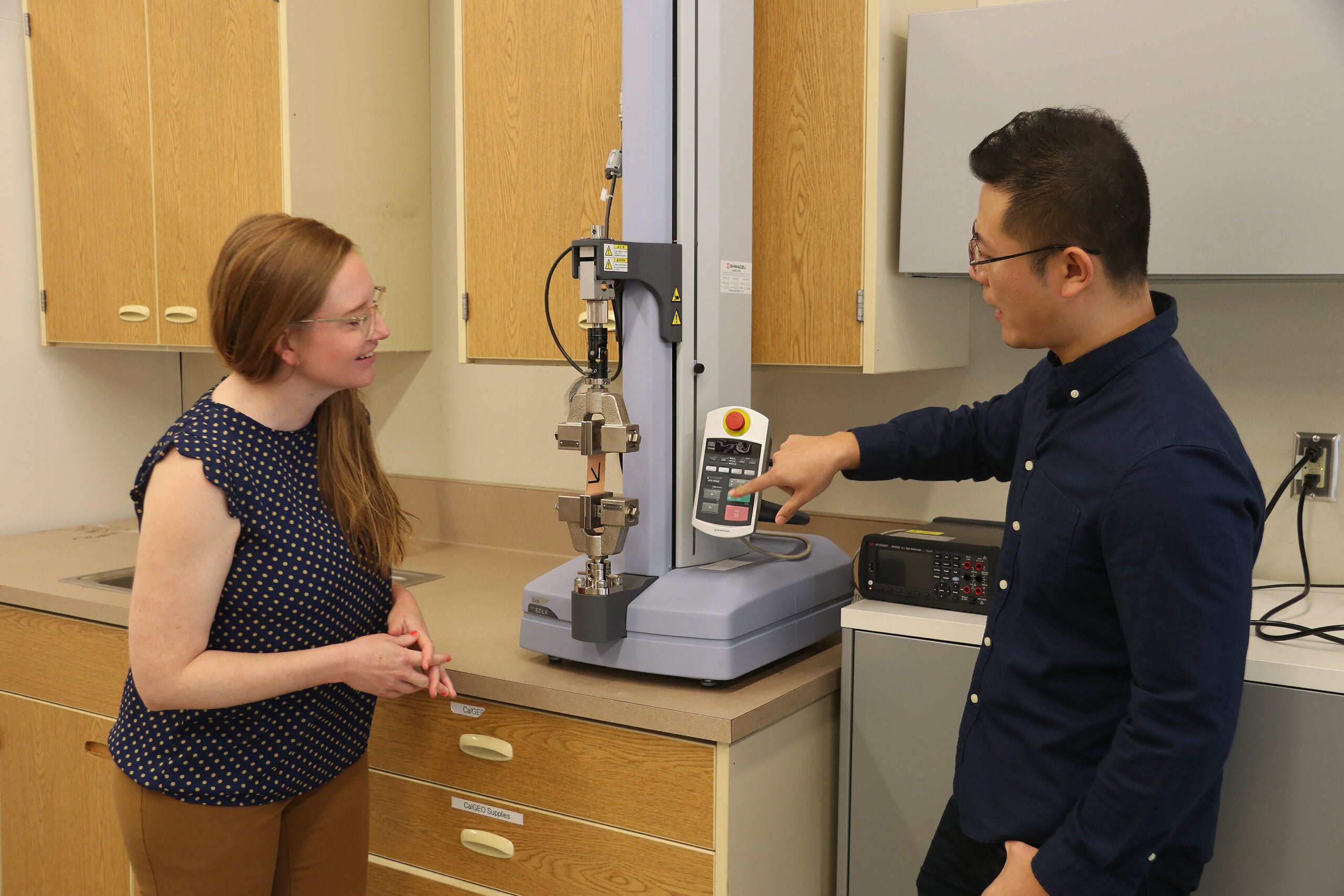 Two professors work in the lab on their spinal tape project
