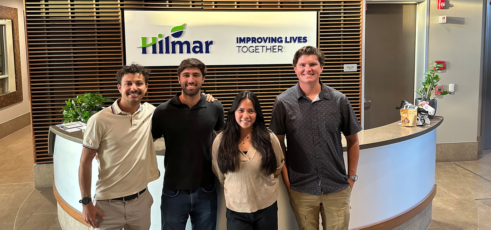 Students pose in front of Hilmar sign