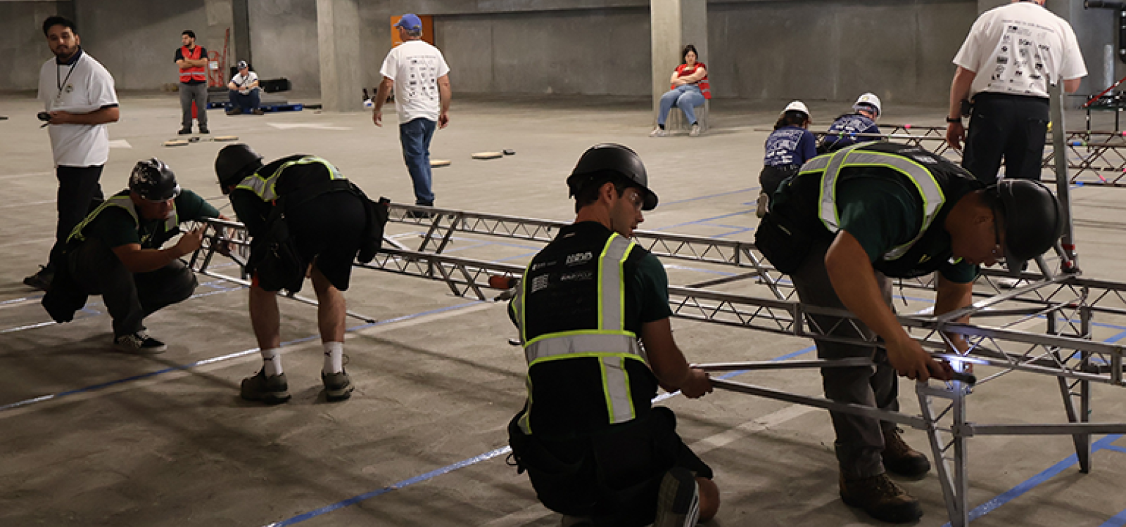 Students construct a steel bridge during competition