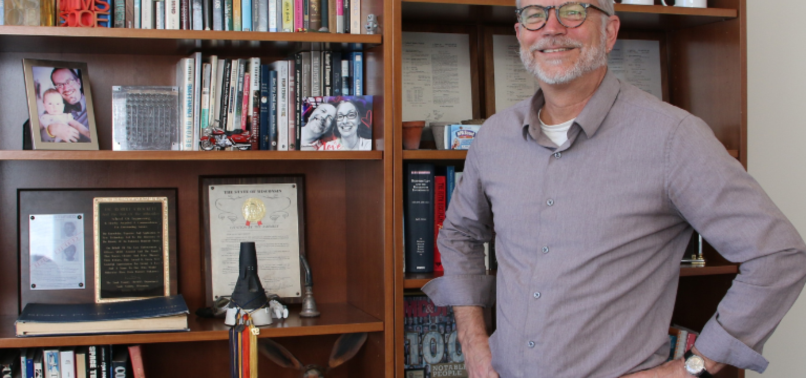 Interim Dean Robert Crockett standing in front of the bookshelf in the dean's office.