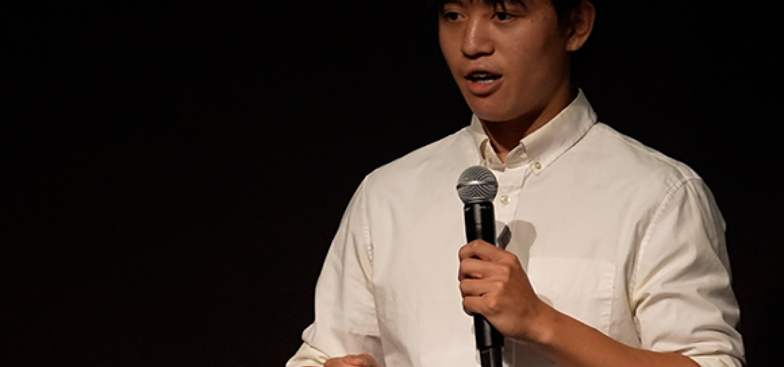 Student presenting on stage