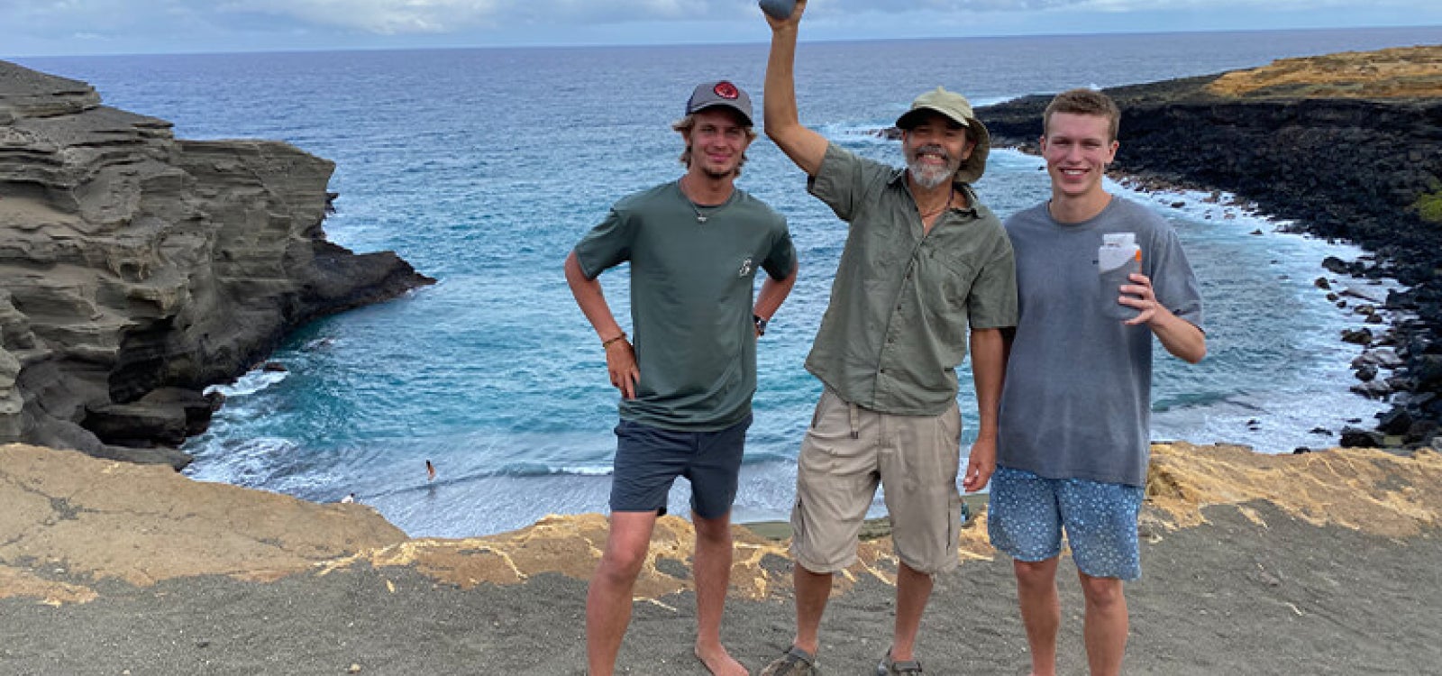 Professor and two students stand on a Hawaii beach where they were researching climate change