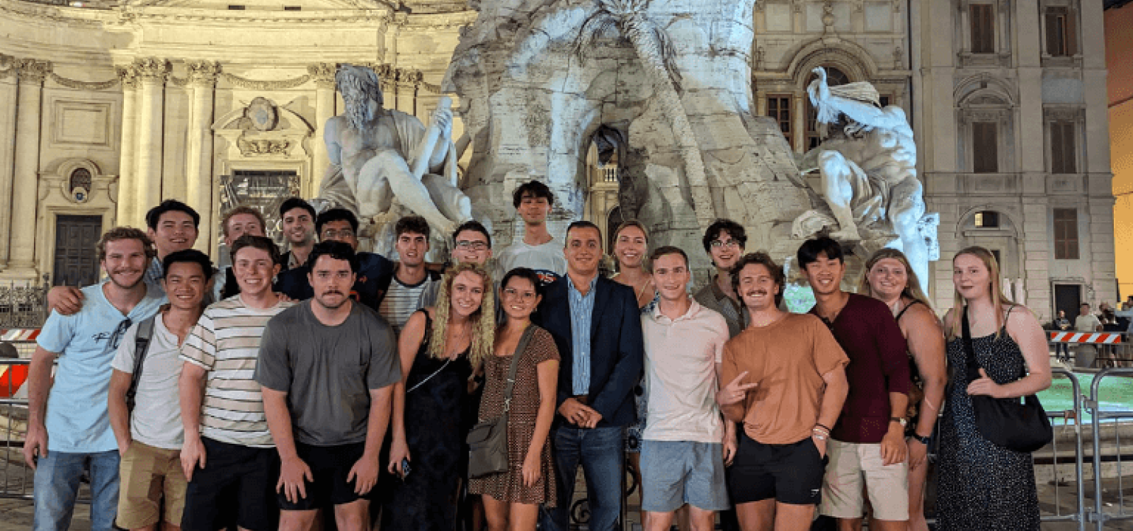Students pose in front of fountain in Rome