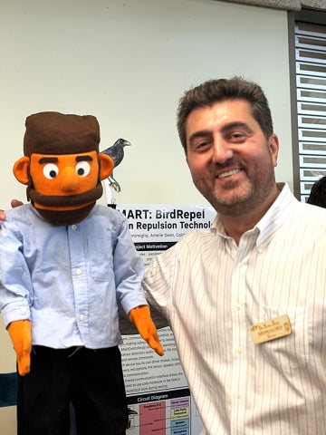 Brian Davis meets “Muppet Me,” the animatronic puppet mechanical engineering students created in his likeness, during Cal Poly’s Engineering Senior Project Expo.