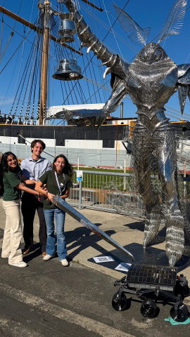 Students stand with their rover along the waterfront in Vallejo