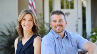 Couple pose for photo on porch