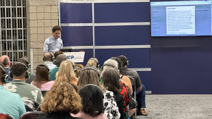 Student presenting in front of an audience