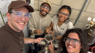 Group members point to the vacuum chamber 