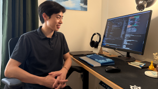 Alumnus sitting at computer