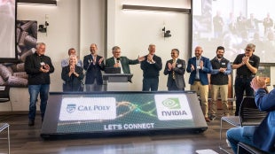 Group participates in digital ribbon cutting, standing next to digital display