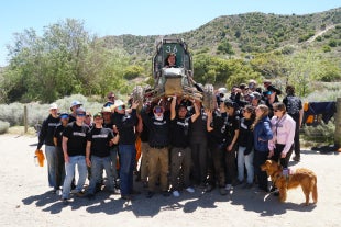 The Baja SAE team hoists their vehicle after completing their dynamic events in Gorman, California
