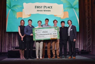ODIN award winners hold their $15,000 check on stage