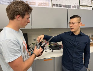 Professor and master's student talk about a collaboration with Sony in a lab