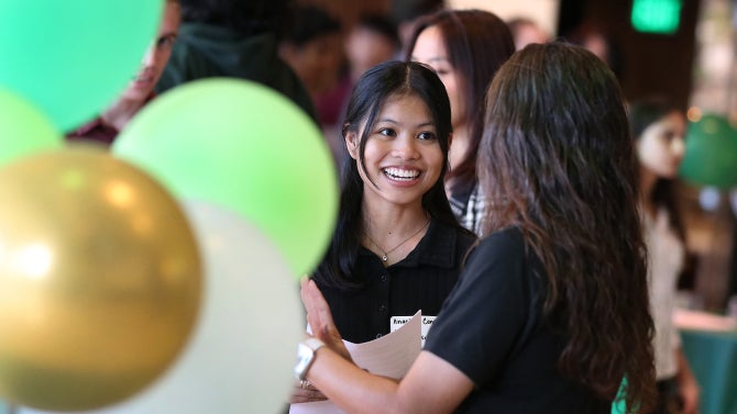 student smiling at event