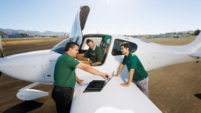 Aerospace Engineering professor Paulo Iscold and students at the San Luis Obispo County Regional Airport with the university’s plane.