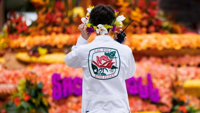 Students and volunteers decorate the Cal Poly Universities Rose Float