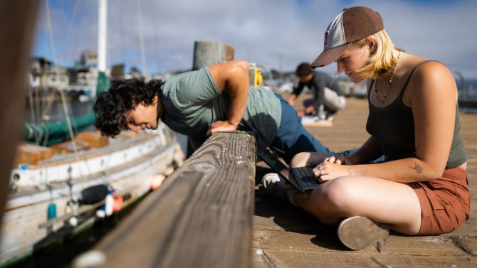 Engineering students in the SURP (summer undergraduate research project) program with associate professor Stefan Talke, civil and environmental engineering, as well as other engineering students deploy tide and wave gauges on one of the piers in Morro Bay.