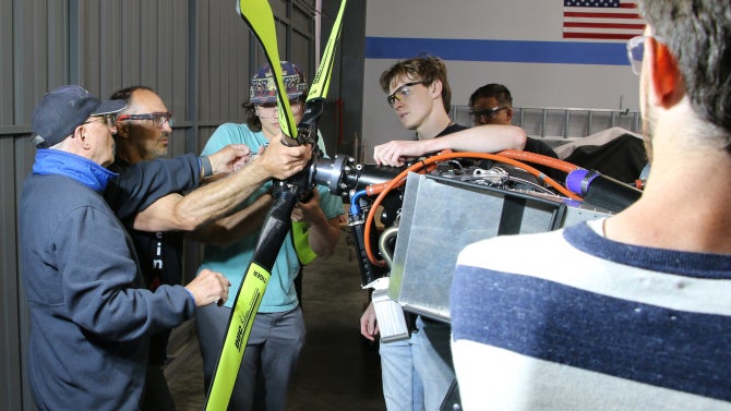 students adding propellor to plane