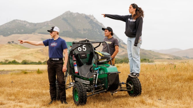 Matthew Shaffer (left), Zach Norris (center) and Selina Bayles review the course during off-road testing with the Cal Poly Racing Baja car. 