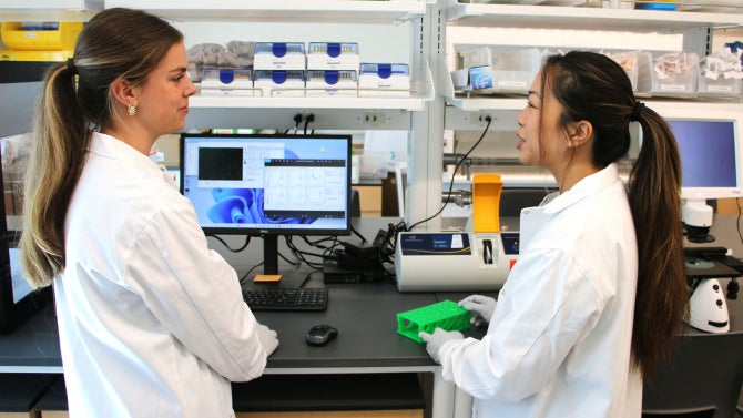 Biomedical engineering students Carly Markowski, left, and Nancy Huang collaborate on cell analysis in the Cell Therapy Lab.