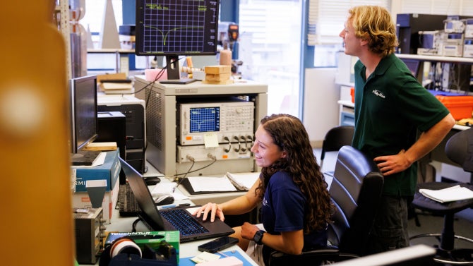 PolySat students work together during CubeSat tuning, ensuring no interference while recording data.