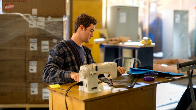 Student uses sewing space in makerspace