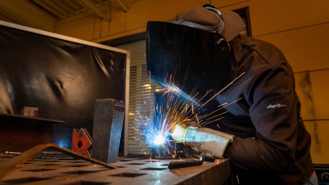 Mechanical Engineering student work on building their senior projects at the Mustang '60 machine shop.