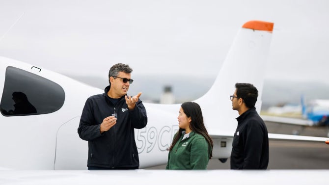 Professor Iscold teachers students near Cal Poly plane