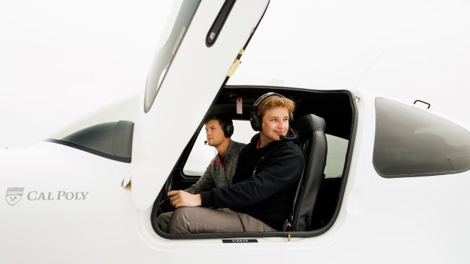 two aerospace students inside airplane