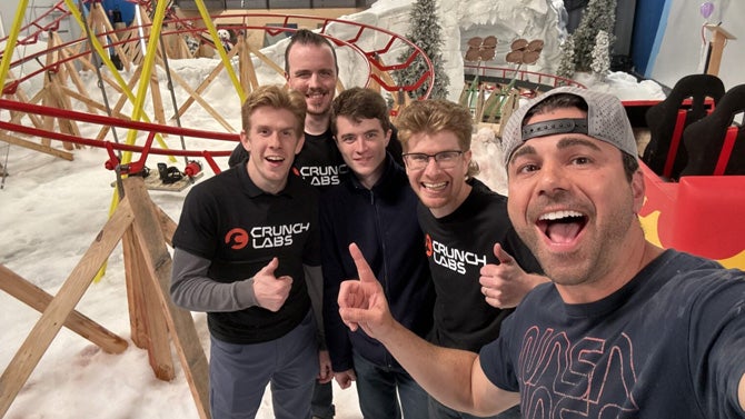 group in front of indoor roller coaster