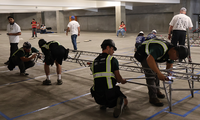 Students construct a steel bridge during competition