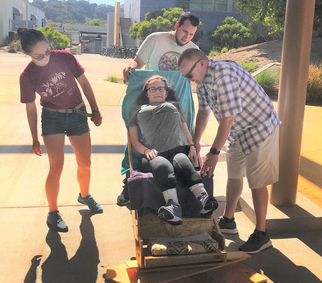 Cal Poly engineering students measure a prototype jogger for Katie Robinson
