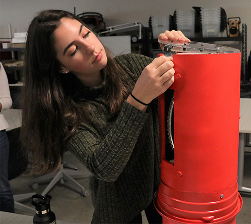 Mechanical engineering student Kylie Fernandez prepares EMBER for a test