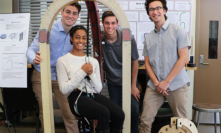 Group of students with a walk harness lifting frame