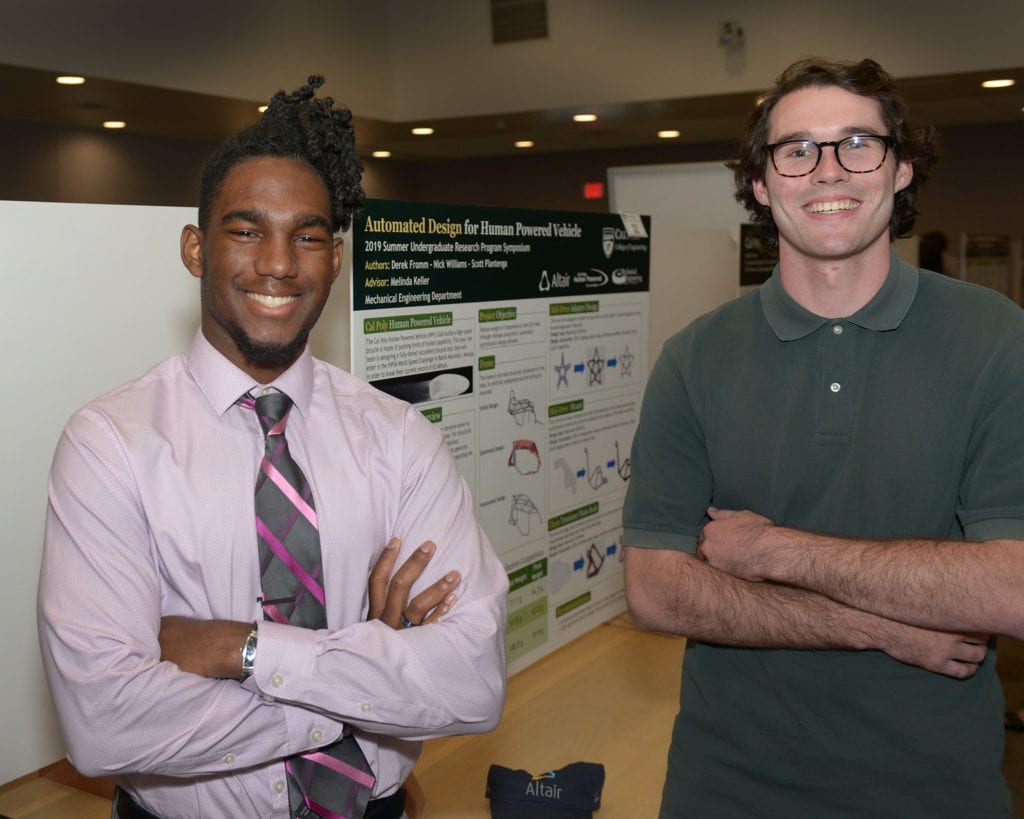 Two students with SURP poster of the Automated Design for Human Powered Vehicle project