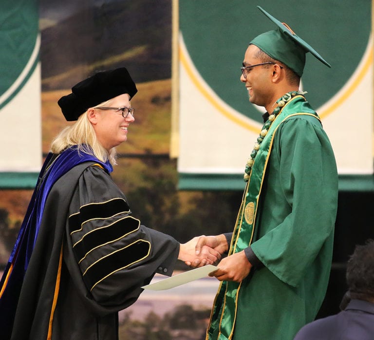 Dean Fleischer shakes hand with engineering graduate