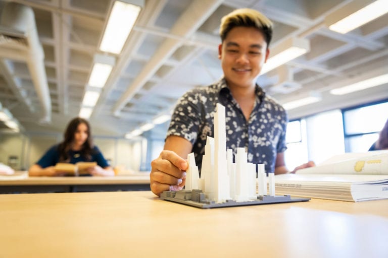 Student at Kennedy Library working on a model building