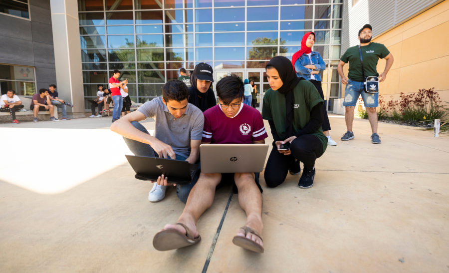 Group of students working outdoors during robotics competition