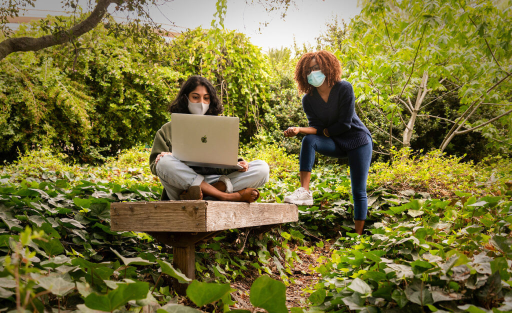 Two students collaborating while outdoors at Cal Poly