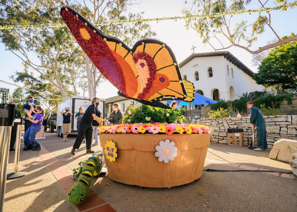 Cal Poly's Rose Float team installed flowers on its Spring Wings public art piece